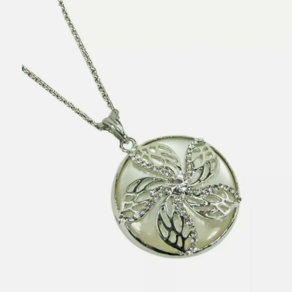 Flower Round Pendant With Crystals Set Into It And On Top Of A White Setting
